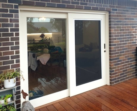 Sliding door painted white Cedar West